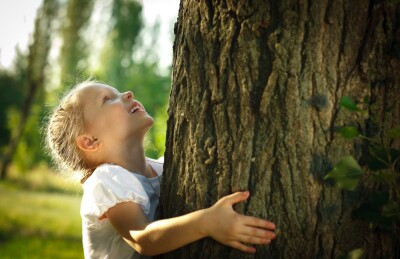 Child hugging tree